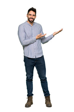 Full-length shot of Elegant man with shirt extending hands to the side for inviting to come on isolated white background