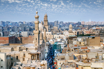 Aerial view of Al-Muizz street of Islamic Cairo with mosques, palaces and residential buildings from the minaret of Sultan Al-Ghuri Mosque-Madrasa, Cairo, Egypt. - 247956379