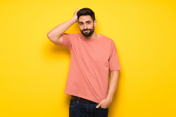 Fototapeta premium Handsome man over yellow wall with an expression of frustration and not understanding