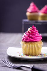 cupcakes with cheese cream and small decorative balls
