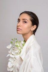 Portrait of Beautiful woman in white dress with wet style hair on white background. Sensual girl profile view