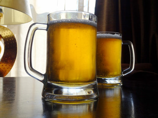 Two full cups of classic cold lager beer detailed   