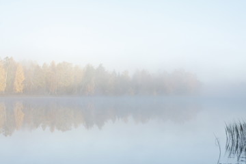 Beautiful autumn morning landscape of Kymijoki river waters in fog. Finland, Kymenlaakso, Kouvola.