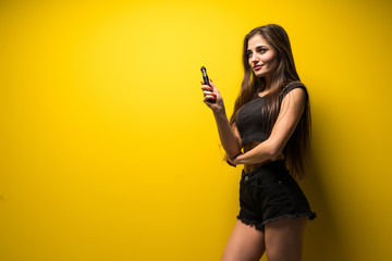 Fototapeta na wymiar Young woman holding vape isolated on yellow background