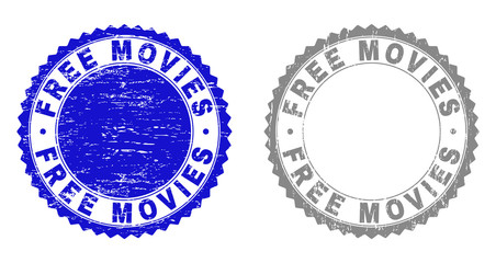 Grunge FREE MOVIES stamp seals isolated on a white background. Rosette seals with distress texture in blue and grey colors. Vector rubber stamp imprint of FREE MOVIES tag inside round rosette.
