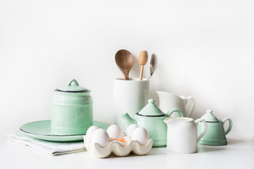 Crockery, tableware, utensils and other different white and turquoise stuff. Kitchen still life.