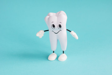 Healthy white tooth. Tooth on blue. Advertising for dentistry.