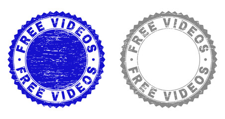 Grunge FREE VIDEOS stamp seals isolated on a white background. Rosette seals with distress texture in blue and gray colors. Vector rubber stamp imitation of FREE VIDEOS tag inside round rosette.