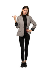 A full-length shot of a Business woman pointing to the side to present a product over isolated white background