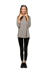 Fototapeta premium A full-length shot of a Young woman with headscarf smiling with a happy and pleasant expression over isolated white background