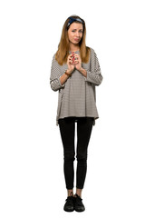 A full-length shot of a Young woman with headscarf scheming something over isolated white background