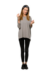 Obraz premium A full-length shot of a Young woman with headscarf making money gesture over isolated white background