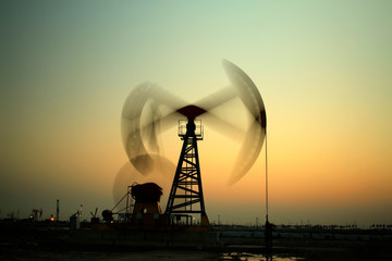 Crank balanced beam pumping unit in Jidong oilfield sunset scenery, closeup of photo