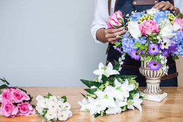 Arranging artificial flowers vest decoration at home, Young woman florist work making organizing diy artificial flower, craft and hand made concept
