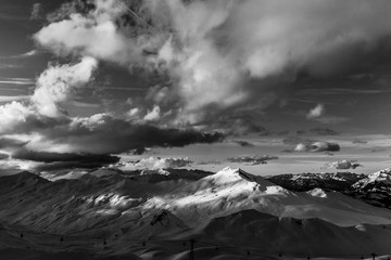 Epic mountains in black and white with some clouds in the evening sun at Davos Switzerland 