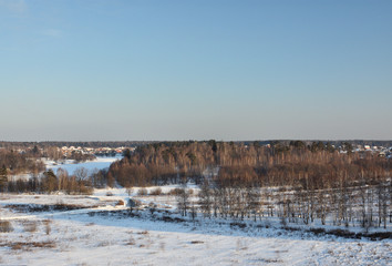 Winter rural landscape with river and forest