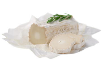 Stick of a goat cheese on paper on  the white background.