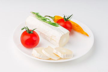 Tasty bushe cheese with rosemary and tomato, on white table