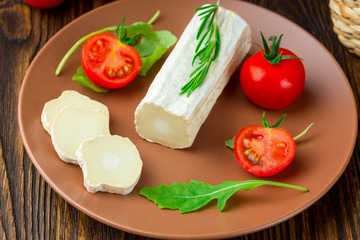 Graviera greek cheese on clay plate.