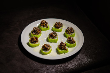 Sushi rolls in white plate and dark background