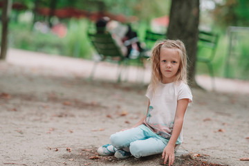 Adorable fashion little girl outdoors in the Tuileries Gardens, Paris