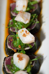 Sushi rolls in white plate and dark background © leonardogonzalez