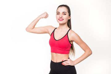 Fototapeta na wymiar Portrait of a beautiful fitness woman showing her biceps isolated on a white background