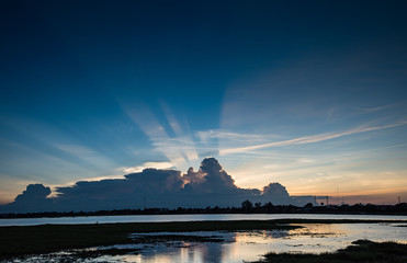 Sunset with light streaks and half of sky lit by setting sun