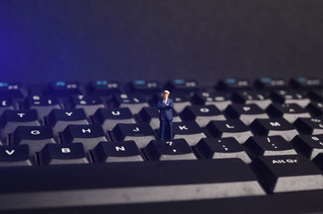 miniature business leader on computer keyboard