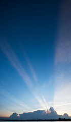 Sunset with light streaks and half of sky lit by setting sun