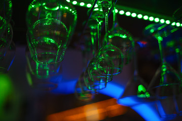 Wine glasses hanging over the bar in the cafe. Abstract image.