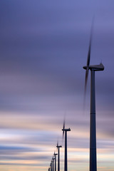 Obraz premium Alternative clean energy is a must these days. Here we see wind parks with many wind turbines in a landscape