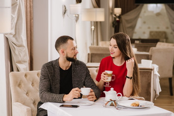 Young and happy couple talking and have fun at the restaurant