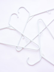 Clothes hanger isolated on white background. Soft focus. Store concept, sale, design, empty hanger.Fashion Banner background. Stock of empty clothes hanger (selective focus) Plastic clothes hanger.