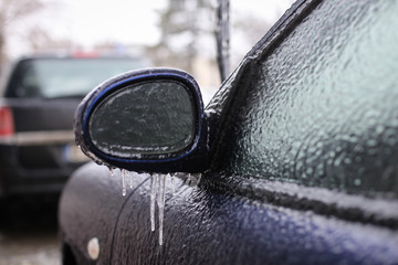 Car frozen side mirror after freezing rain