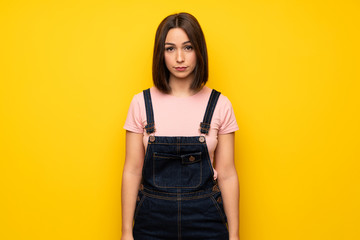 Young woman over yellow wall portrait