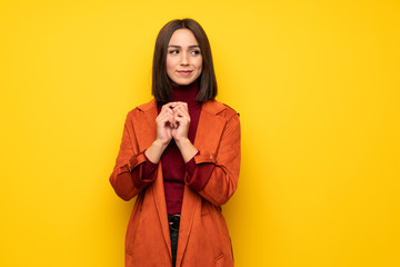Young woman with coat scheming something