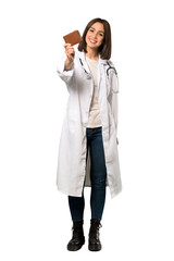 A full-length shot of a Young doctor woman holding a wallet over isolated white background