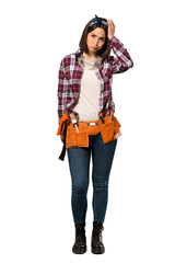 A full-length shot of a Young worker woman with an expression of frustration and not understanding over isolated white background