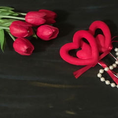 Valentine's day background with red heart ,pearls and red tulips