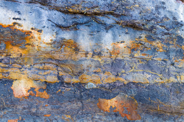 Colourful stone background texture, abstract formation of mineral rock in marine environment