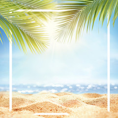 Summer background with frame, nature of tropical golden beach with rays of sun light and leaf palm. Golden sand beach close-up, sea water,  blue sky. Copy space, summer vacation concept.