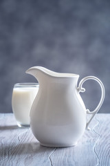 Pouring fresh milk into glass close up.