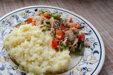 couscous, meat, bell pepper and green beans on a plate