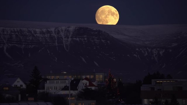 Full moon cresting Esja mountain, downtown Reykjavik Iceland traffic.mov