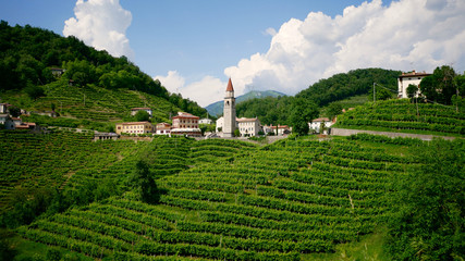 View of the green Prosecco wine hill and blue sky in background - Rolle - Cison di Valmarino -...