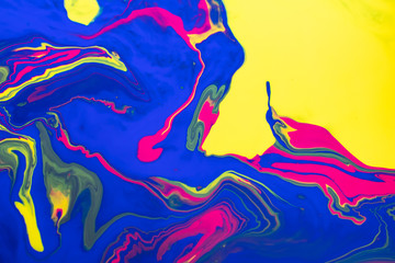 Abstract painting background in vivid colors. Marbleized bright effect with fluid painting, background for wallpapers, poster, postcard. Swirls and lines with yellow, blue, magenta white. Pop colors