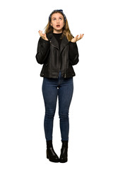 Obraz premium A full-length shot of a Teenager girl with leather jacket frustrated by a bad situation on isolated white background