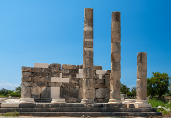 Antique ancient Temple Leto, the goddess of Greek mythology on the ruins of Letoon. Beautiful landscape on the background of clean blue sky Turkey.