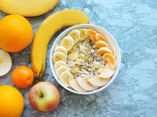 Healthy breakfast. Close-up, top view, isolated background. Concept of healthy and tasty food. Fitness breakfast. muesli bowl with sliced banana. Muesli breakfast with oatmeal cereals raisins. 